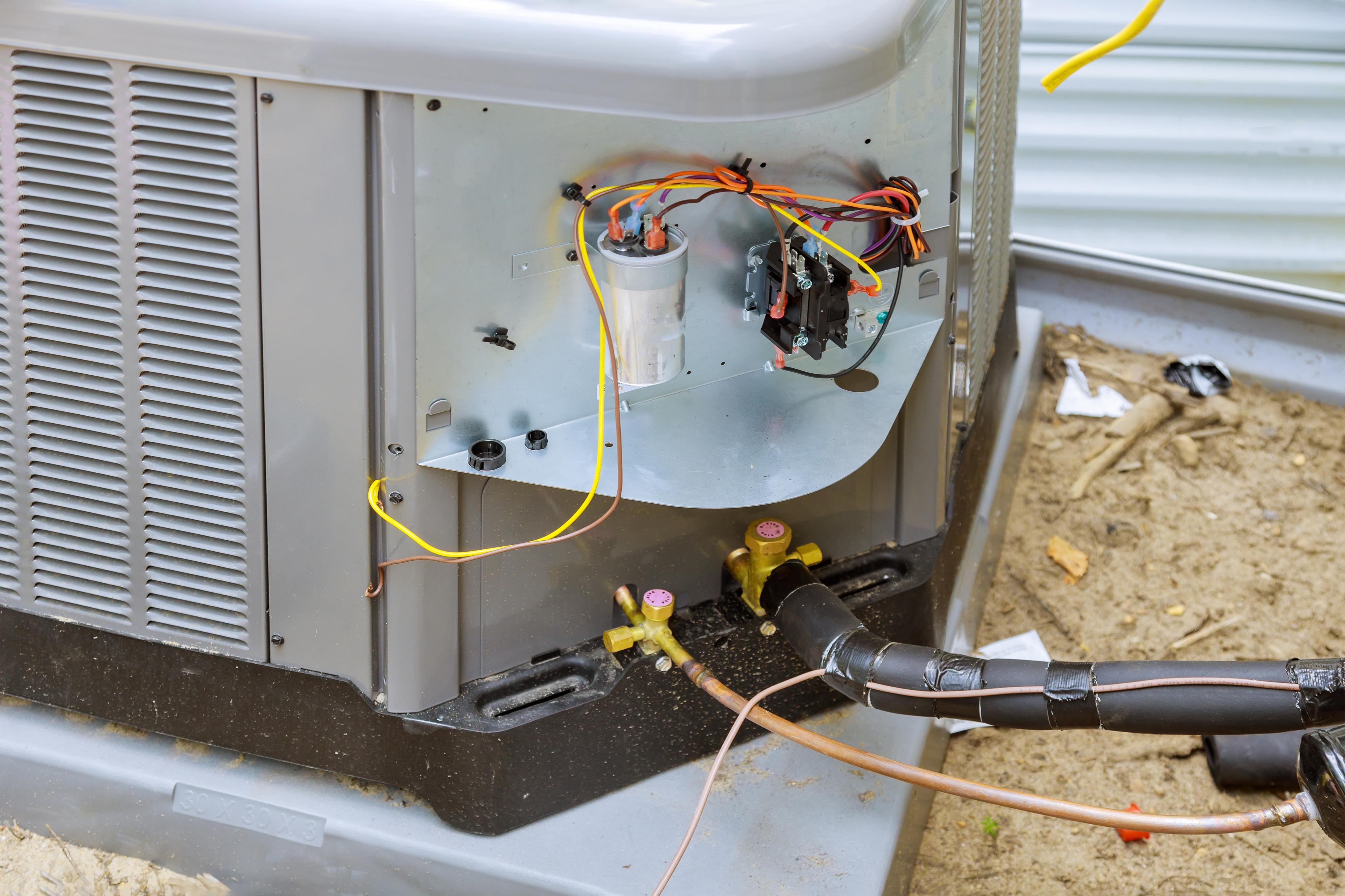 Airz technician servicing an outdoor air conditioning condenser unit